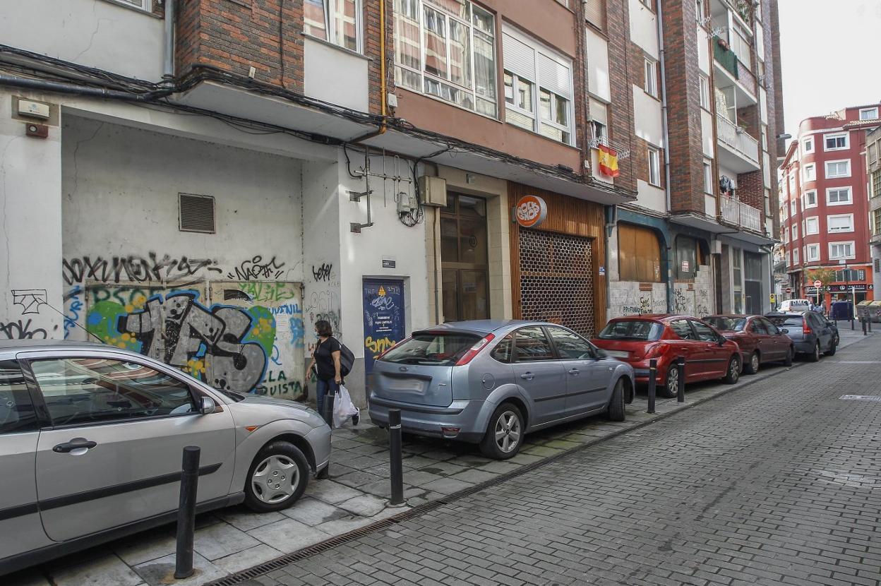 Una mujer camina junto a la fachada en la que se producen las filtraciones en la calle Lasaga Larreta.