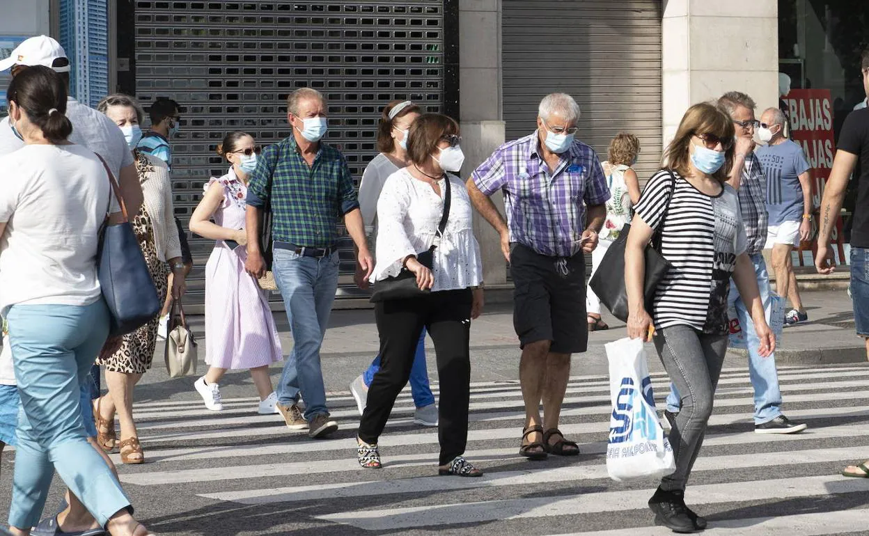 Vecinos de Santander, por el centro de la ciudad, con mascarilla. 