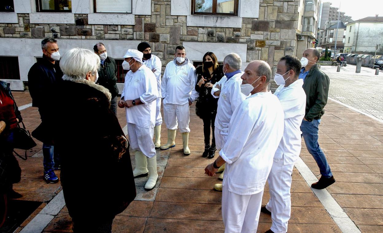 Trabajadores del matadero municipal de Barreda conversan con los concejales de los grupos de la oposición en el Ayuntamiento.