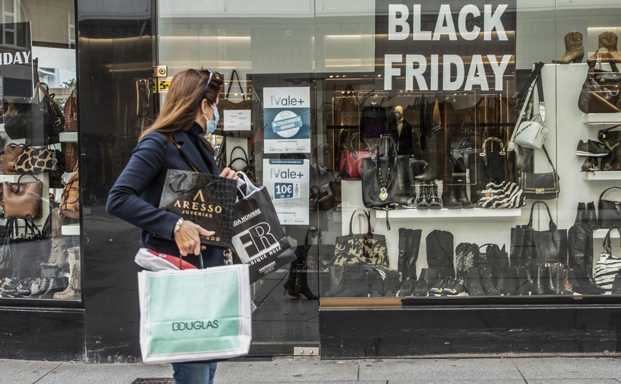 Una mujer observa las ofertas del 'viernes negro' en un escaparate del centro de Santander. 