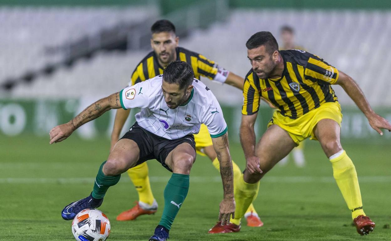 Álvaro Cejudo, que volvió a ser titular, intenta proteger el balón presionado por la defensa del Barakaldo.