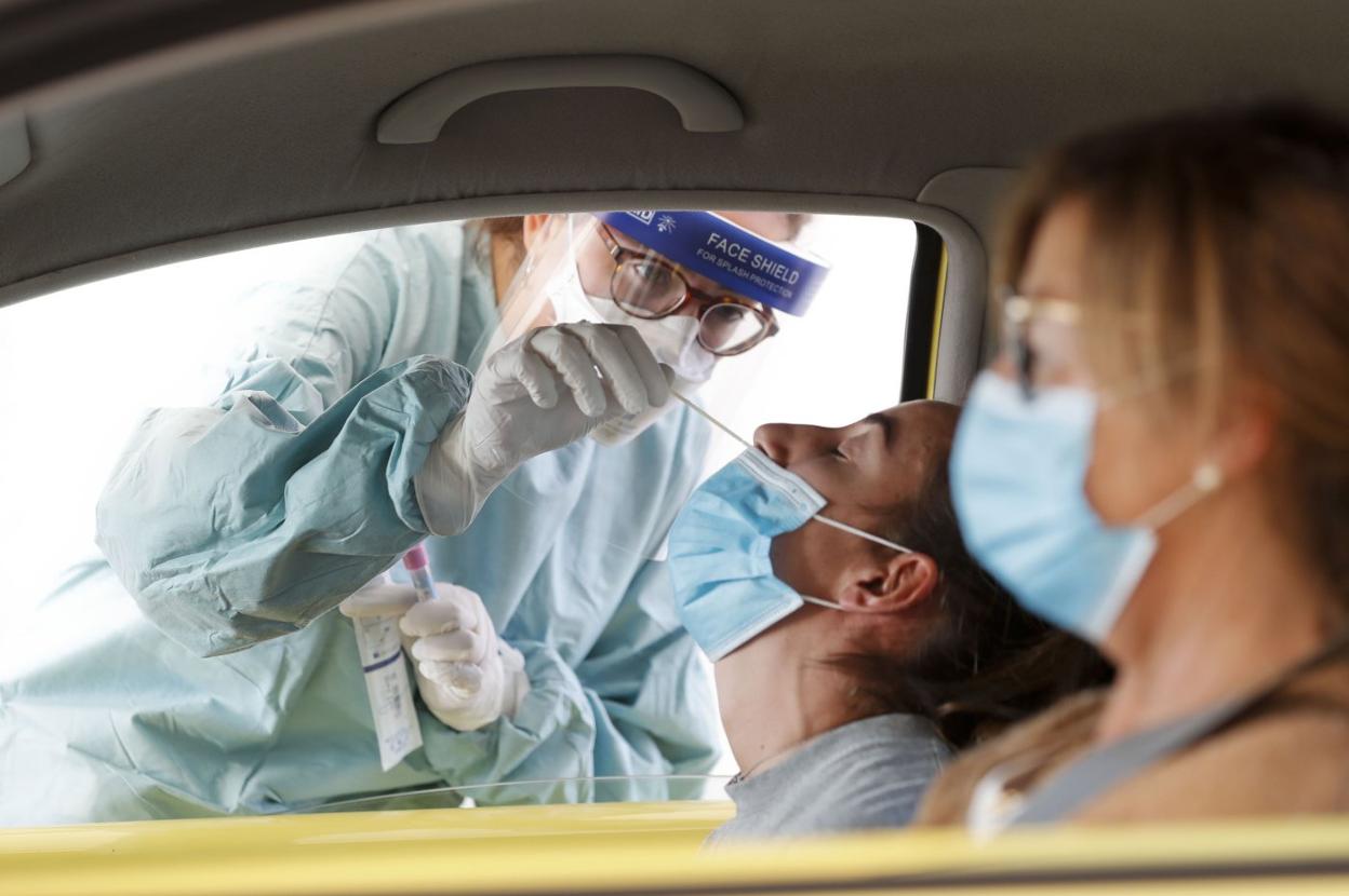  Un sanitario recoge la muestra para un test.