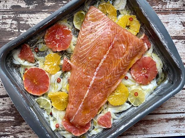 Salpimentar y colocar el salmón en la bandeja de horno y regar con abundante aceite.