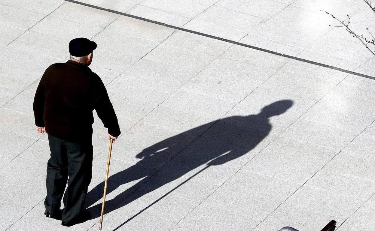 Un pensionista pasea por la calle. 