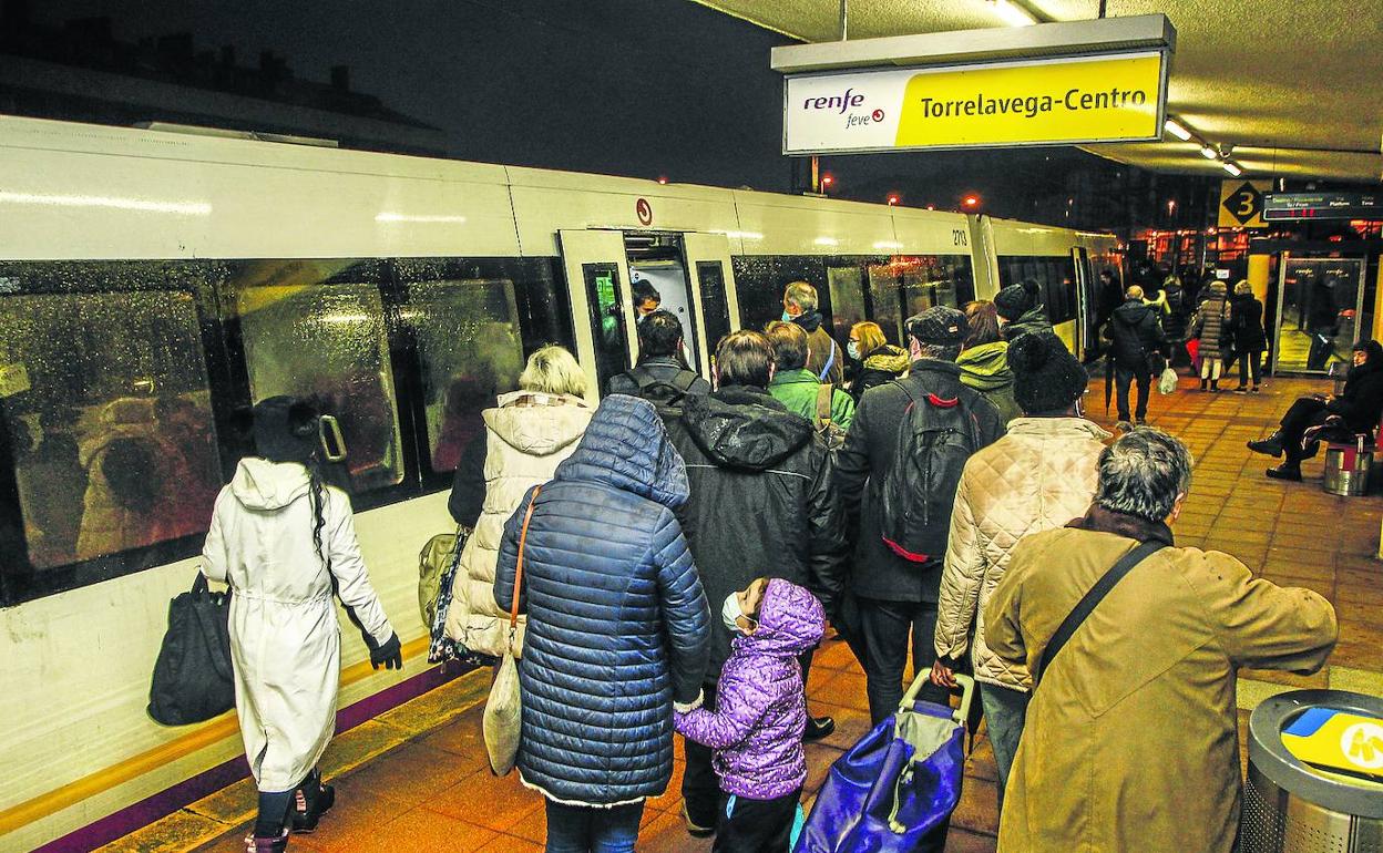 Los viajeros acceden al tren de Cercanías en la estación de Torrelavega. Partió con ocho minutos de retraso sobre el horario previsto. 