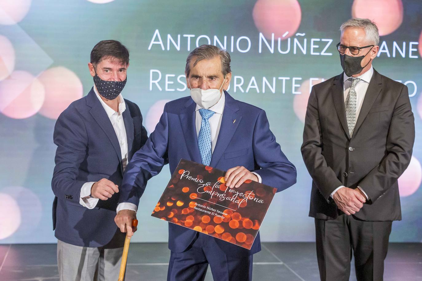 José María Bueno y Timoteo Antuñano entregan el premio a la trayectoria empresarial a Antonio Núñez Seoane, del restaurante El Puerto.