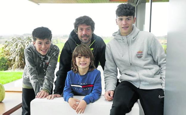 El ciclista Óscar Freire y sus tres hijos, Mateo, Manuel y Marcos, en el jardín de su casa