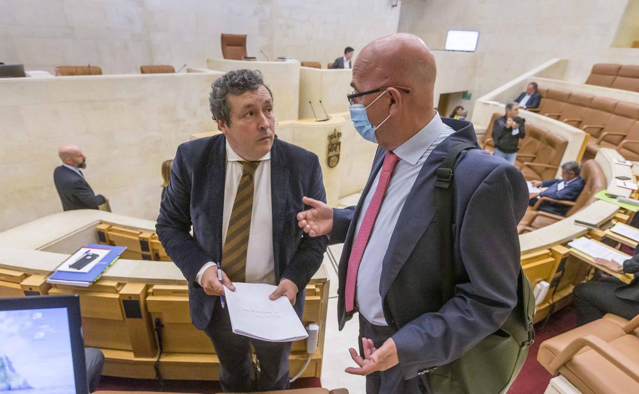 El portavoz del PP, Íñigo Fernández, charla con su compañero César Pascual antes del inicio del Pleno de este lunes. 