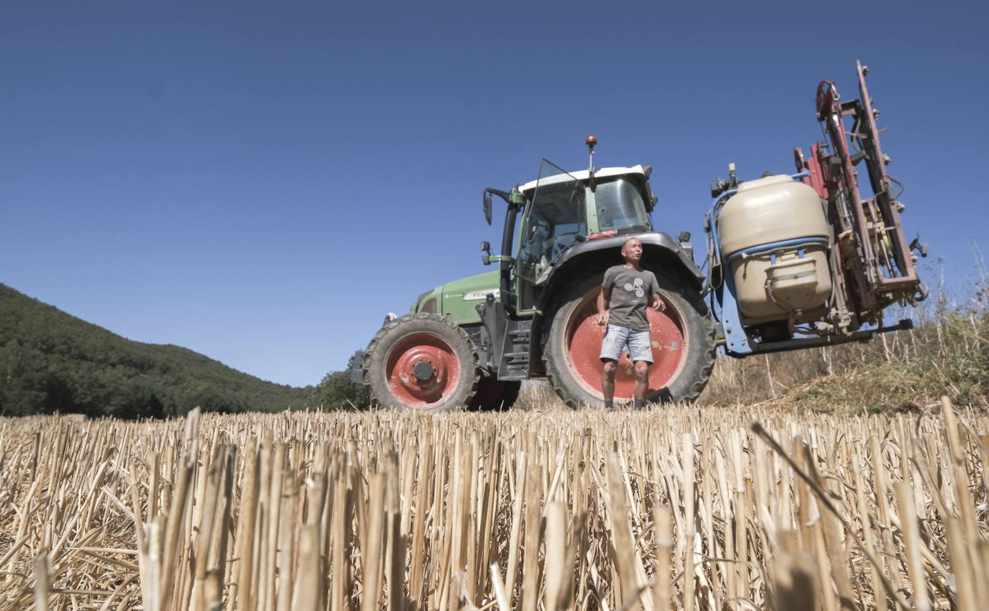 José María López, agricultor y ganadero, junto a su tractor en las seis hectáreas de terreno que tiene en Valderredible donde siembra cereal, maíz y patata.