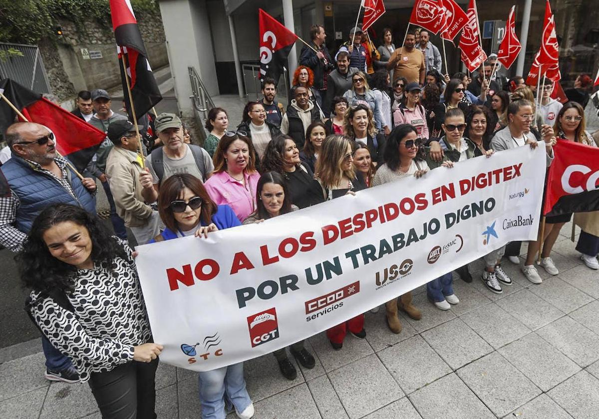 Los trabajadores portan una pancarta exigiendo que no haya despidos, en la protesta de esta mañana junto al hotel NH Santander.