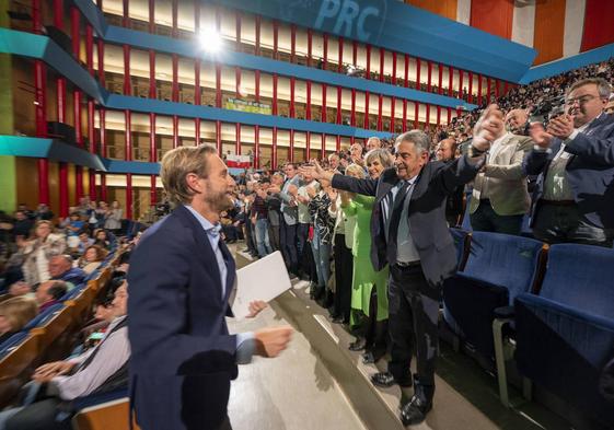 El candidato en Santander, Felipe Piña, se dirige a abrazar al presidente tras su intervención en el escenario del Palacio de Festivales durante el mitin.