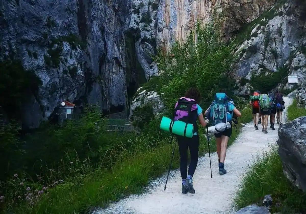 Varias personas, durante una ruta de senderismo por la montaña.