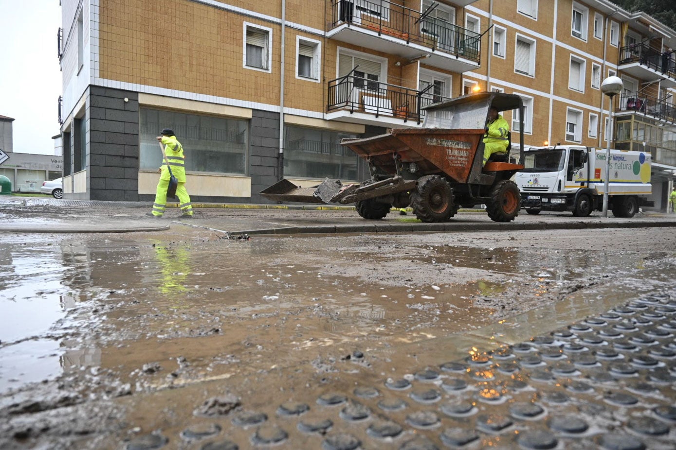 Los operarios del servicio de limpieza de Laredo trabajan para eliminar el rastro de las inundaciones en las calles del municipio.