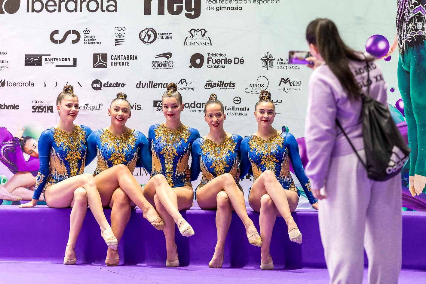 Un grupo de gimnastas descansa tras haber realizado su coreografía. 