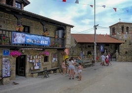 La tienda de artículos de recuerdo ocupa el centro de la plaza del pueblo con un gran cartel en inglés.