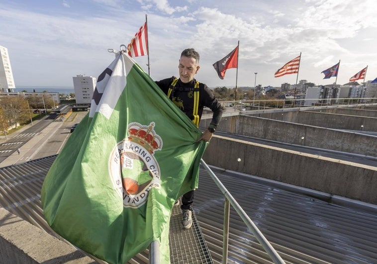 Tomás Carrera, el jefe de mantenimiento del club, iza la bandera del Racing en el primer puesto en lo alto de los Campos de Sport.