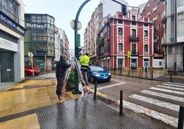 Operarios de la adjudicataria reparan uno de los semáforos de la calle José María Pereda, este martes a primera hora de la tarde, en Torrelavega.