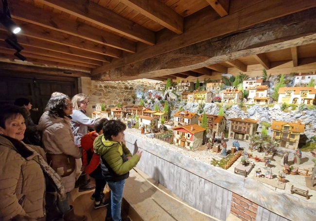 Varias personas visitan el belén de Barcenaciones.