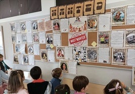 Alumnado del CEIP Costa Quebrada ante un panel con personajes históricos del proyecto 'Time Traveler.