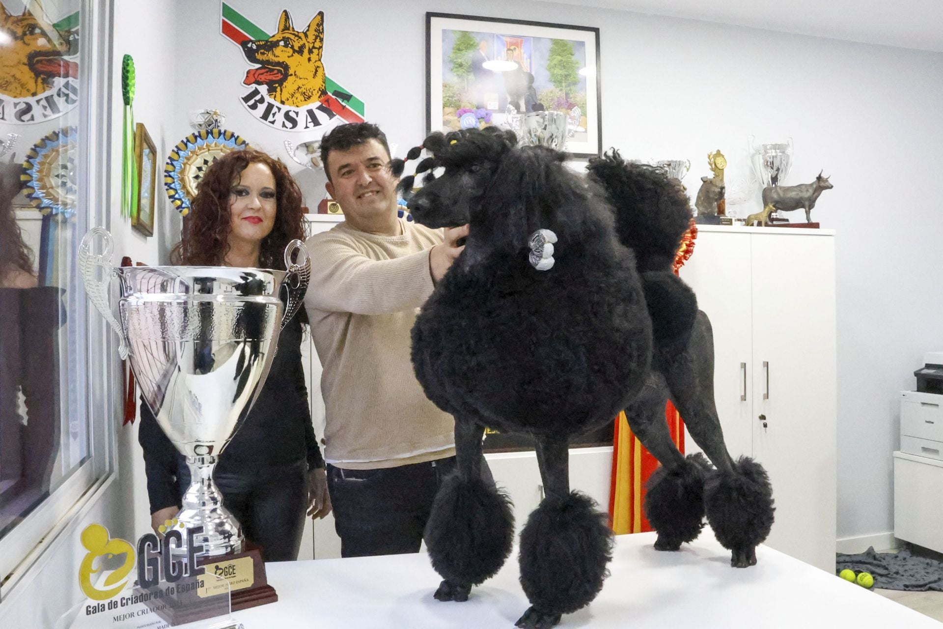 La perra llamada 'Del Besaya Viento del Norte' junto a sus orgullosos criadores y a su trofeo.