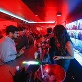 Una camarera sirve unas copas a un grupo de jóvenes en el interior de una discoteca, en una imagen de archivo.