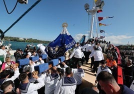 Los picayos llevando la imagen de la Virgen de la Barquera momentos antes de embarcar
