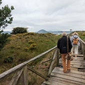 Dos turistas pasan por la pasarela en el verano de 2023, antes de ser arreglada por el Ayuntamiento pejino por primera vez.