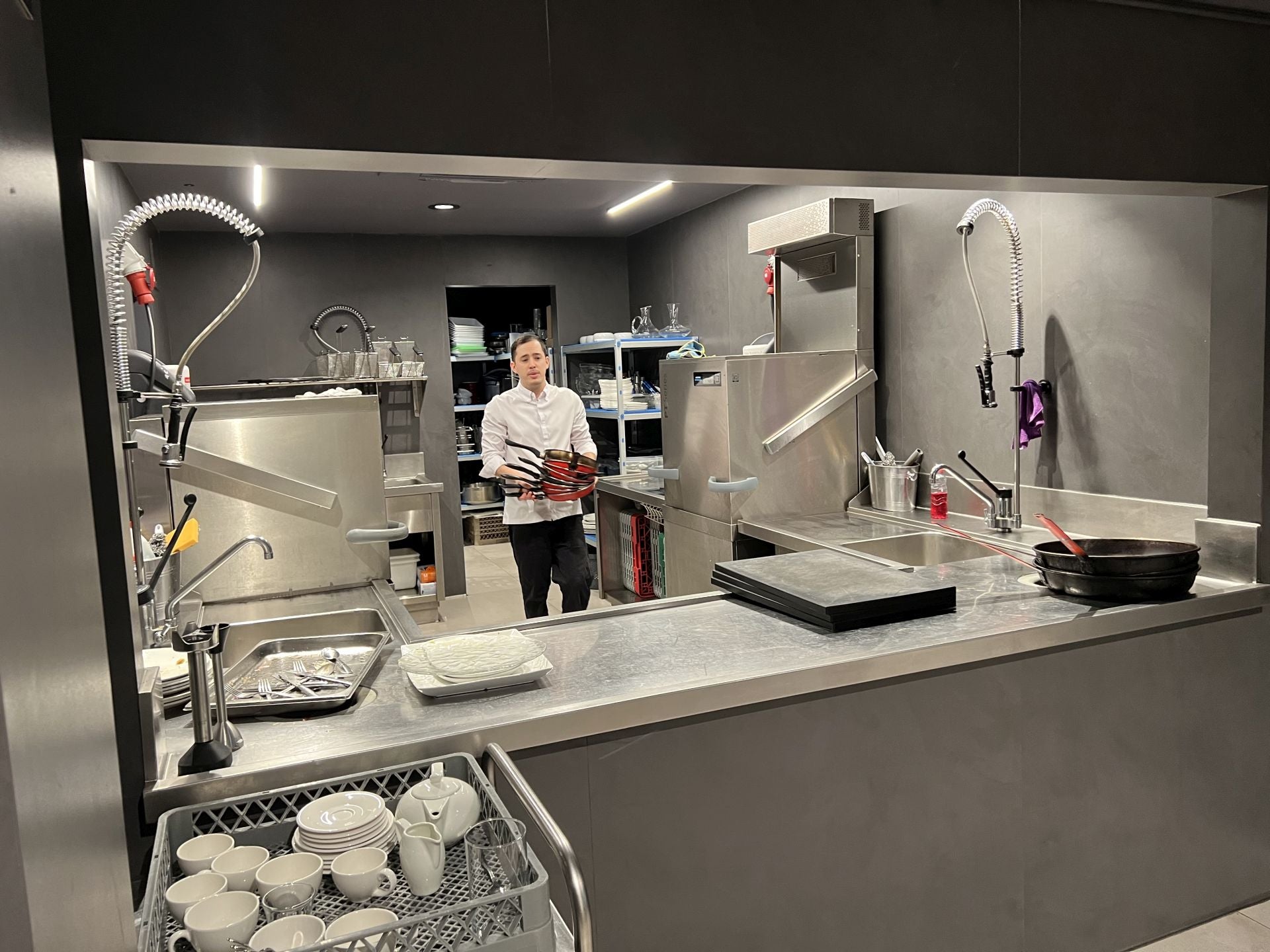 El equipo de cocina, tras cambiarse en los vestuarios, recogen del almacén ubicado detrás del office (dónde se lava todo durante y después del servicio) las cazuelas, sartenes y menaje necesario para empezar a cocinar. En este caso es Lucas quien aparece en la foto.