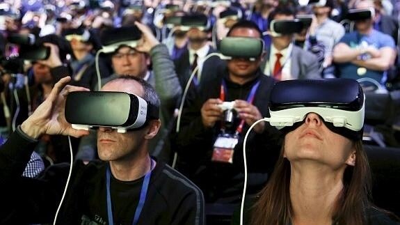 Espectadores del Mobile World Congress prueban unas gafas de realidad virtual durante una exposición.