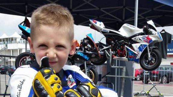 El pequeño Marco junto a su minimoto.