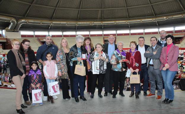 Participantes premiadas con las autoridades sobre el escenario de la plaza de toros de La Flecha. 