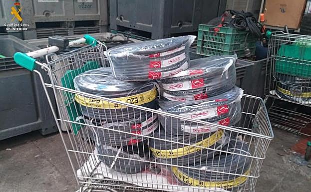 Fotografía facilitada por la Guardia Civil de Palencia en la que se observa uno de los carros localizados con los paquetes de cable en el interior de la chatarrería de Valladolid. 