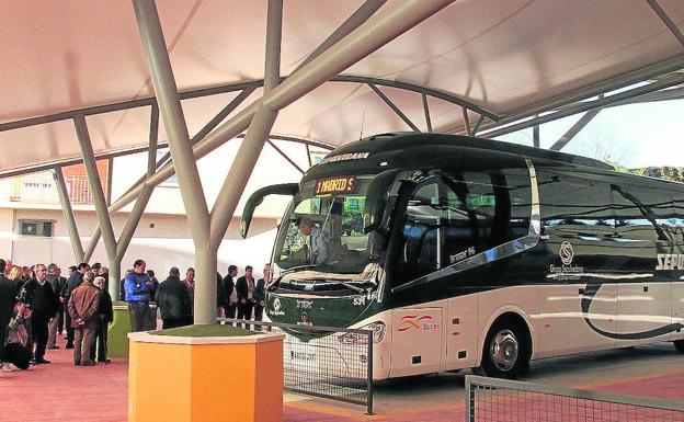 Público y un autobús en la dársena de la estación de autobuses. 