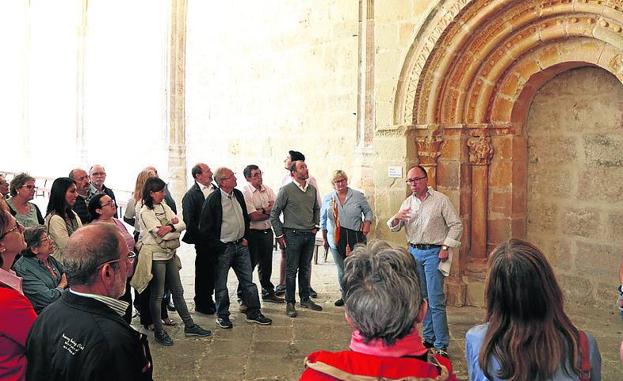 Pedro Luis Huerta, a la derecha, delante de la portada románica en el claustro de la catedral.