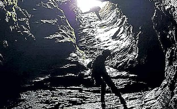 Agentes del EREIM de Riaza se descuelgan por una cueva.