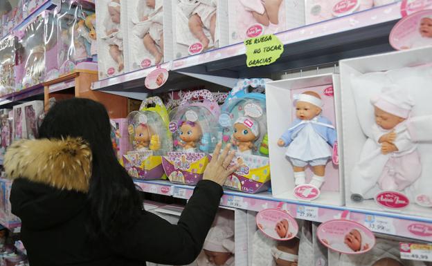 Una mujer observa la colección de 'Bellies' en una juguetería de la ciudad.