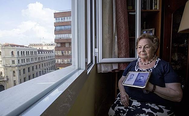 Mercedes Abril, con una foto de sus padres, en su casa de Valladolid. 