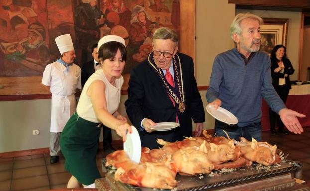 Aitana Sánchez-Gijón y José Sacristán participan en el ritual de trinchar el cochinillo junto a Alberto López en un descanso del rodaje de la serie Velvet, en el Hotel Cándido. 