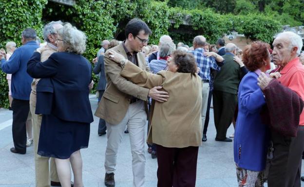 El portavoz socialista, Pedro Herrero, bailando con una mujer en la pérgola del Campo Grande. 