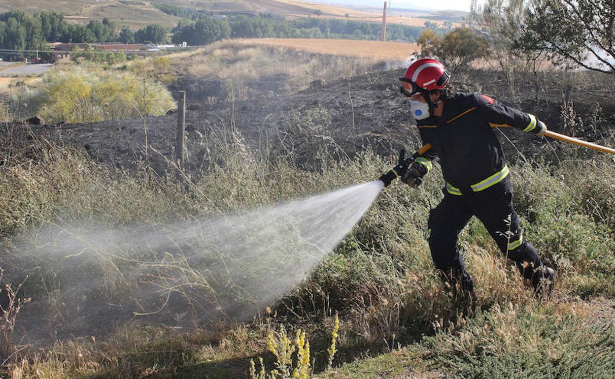 Un bombero trata de sofocar un incendio. 