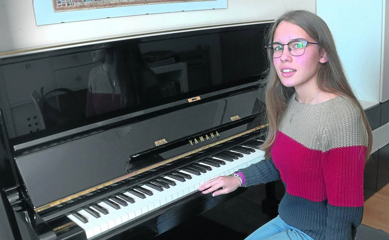 Sentada al piano en su casa de A Coruña. Inés, de 16 años, no está dispuesta a apagar su voz ante las injusticias.