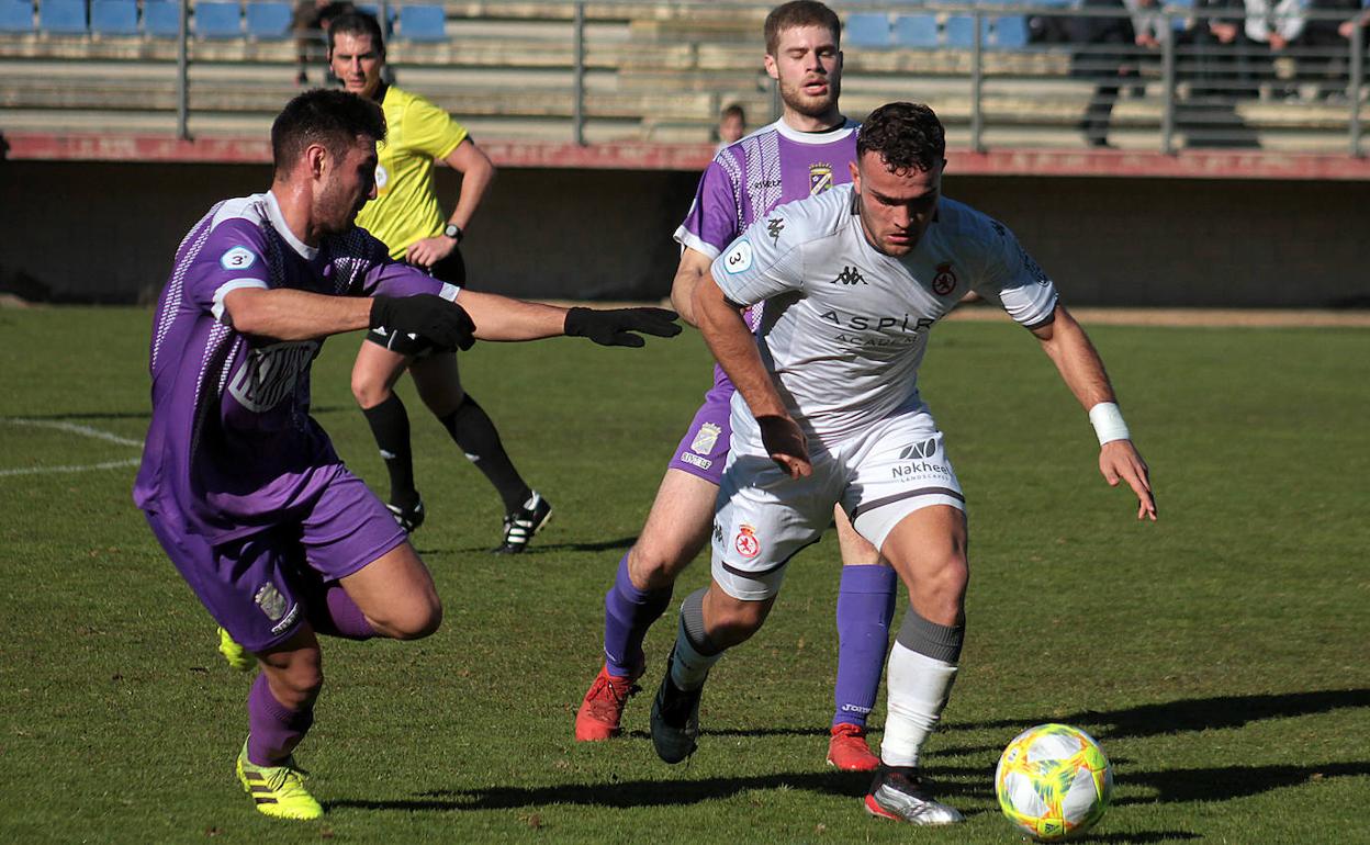 Carlos trata de detener el avance de un rival del Júpiter Leonés B. 