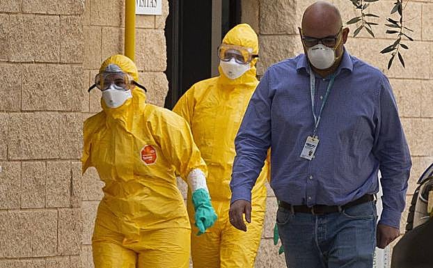 Tres personas, ataviadas con trajes de protección y mascarillas, en el Parque Tecnológico de Boecillo, donde se identificaron los primeros casos de coronavirus en Valladolid. 