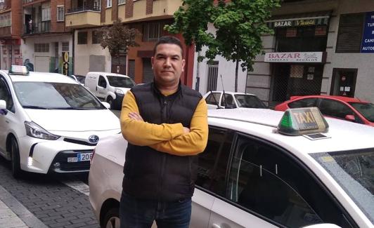 Mohamed El Bouhali, junto al taxi con el que recorre Valladolid