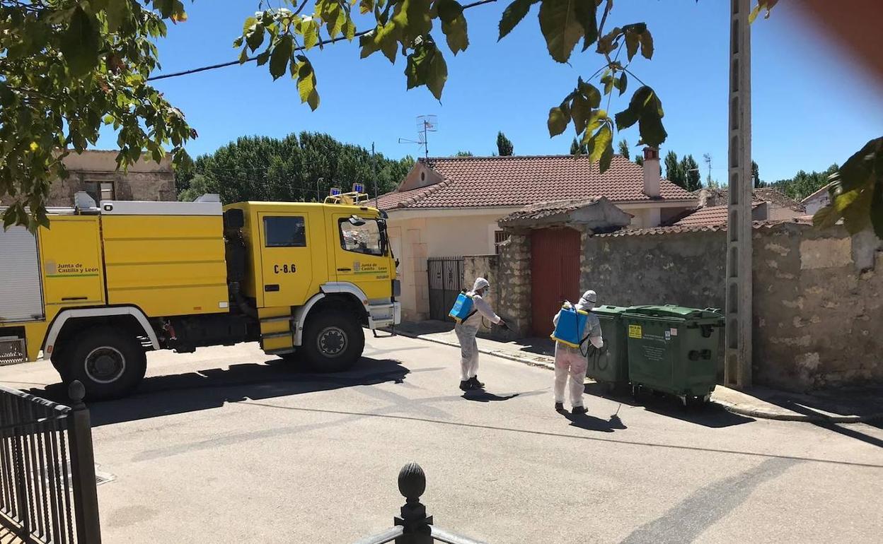 Equipos de la Junta desinfectan este miércoles contenedores y mobiliario del casco urbano de Carrascal del Río. 