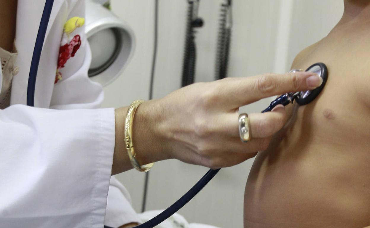 Una pediatra ausculta a su paciente.