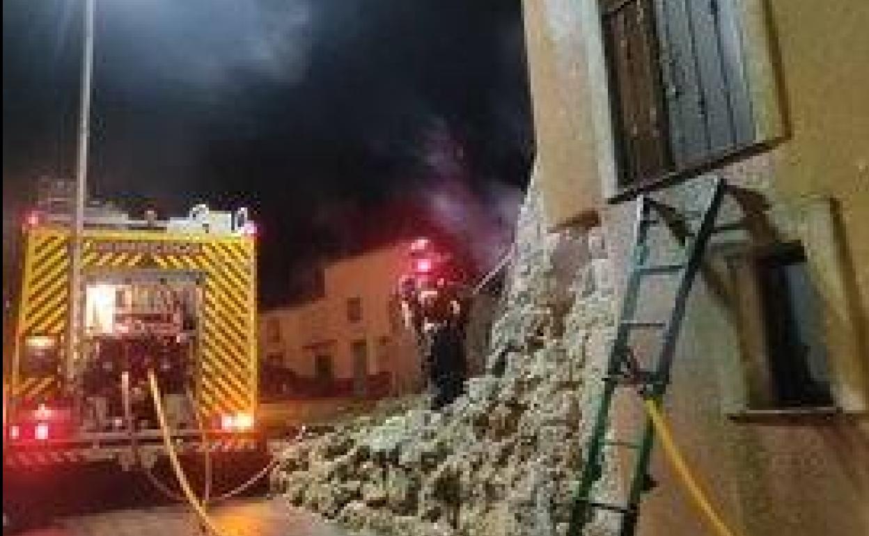 Un bombero apaga el fuego en la vivienda. 