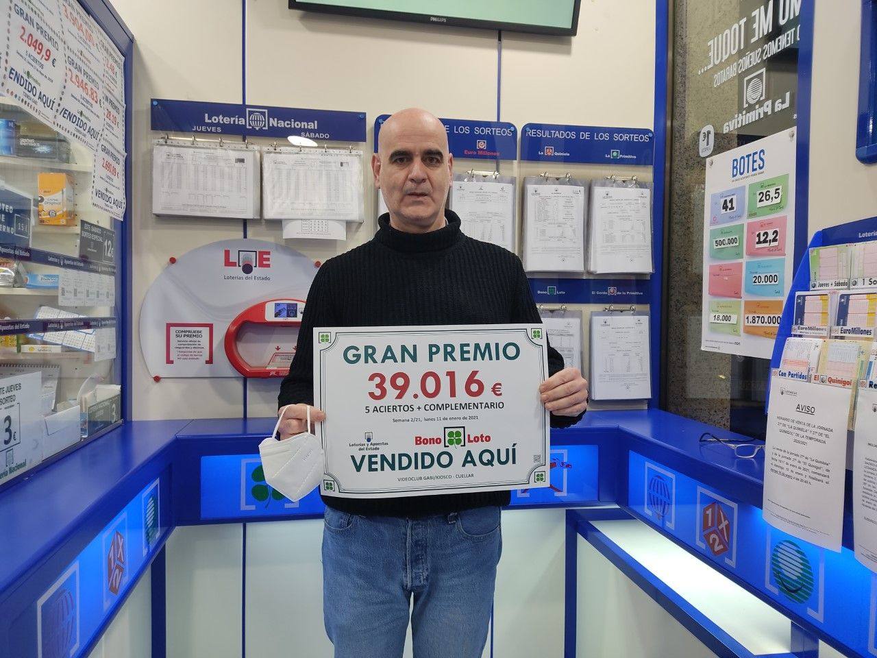 Fernando Senovilla, con el cartel del número premiado y sellado en su establecimiento.