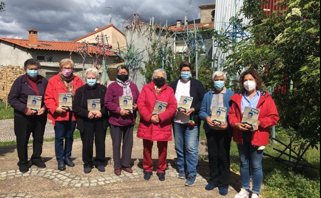 Una representación de las mujeres que han participado en el libro, con la publicación en las manos.