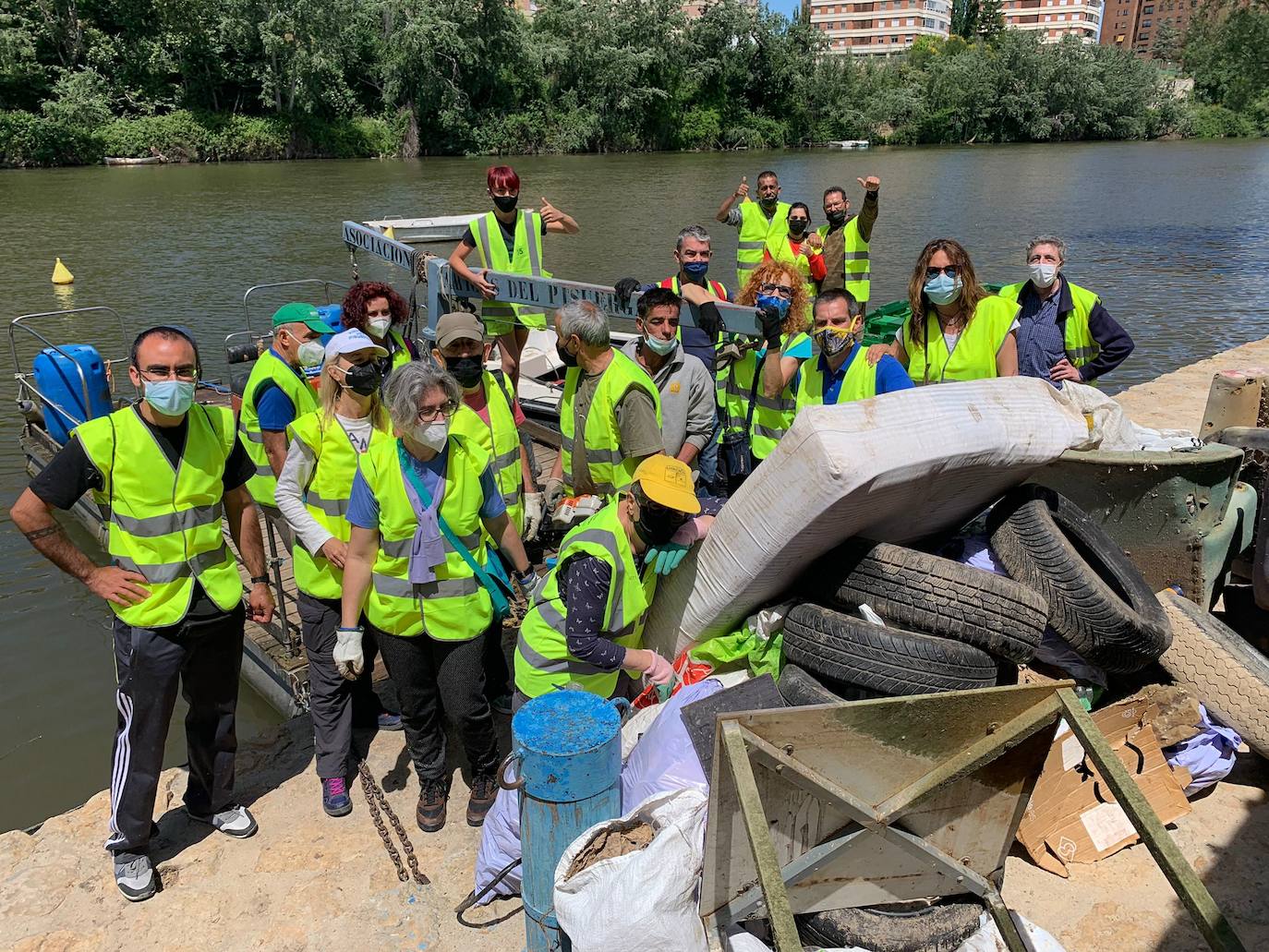 Los voluntarios, con algunos de los enseres retirados del río y de la ribera del Pisuerga. 